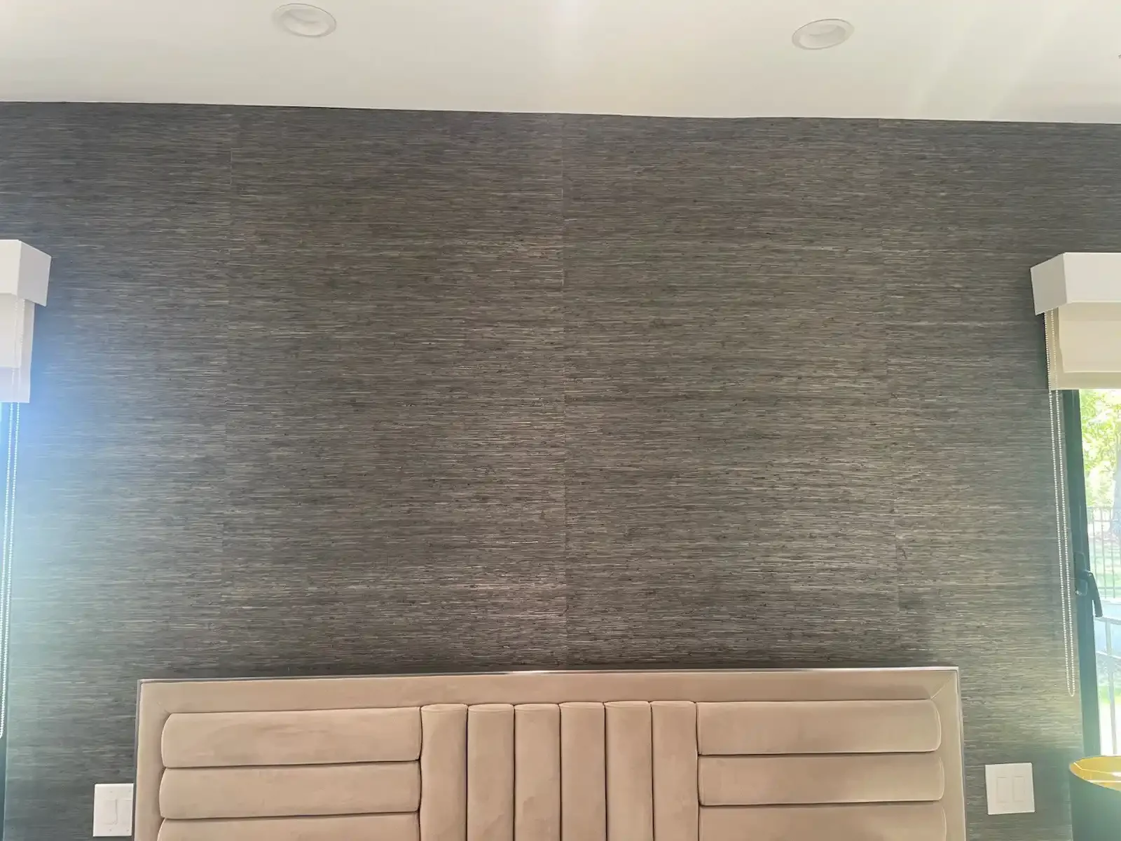 A dark geometric wallpaper wall used as an interior accent